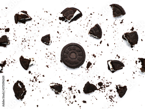 Sandwich chocolate cookies with a sweet cream with crumbs isolated on white background.