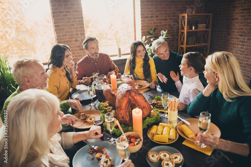 Portrait of nice attractive cheerful cheery positive family brother sister parents grandparents meeting eating tasty yummy meal luncheon occasion at modern loft brick industrial interior