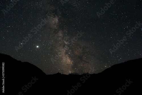Starry sky and milky way in the mountains. Starry sky and milky way in the mountains. Mountain village against the background of the night starry sky and the milky way.
