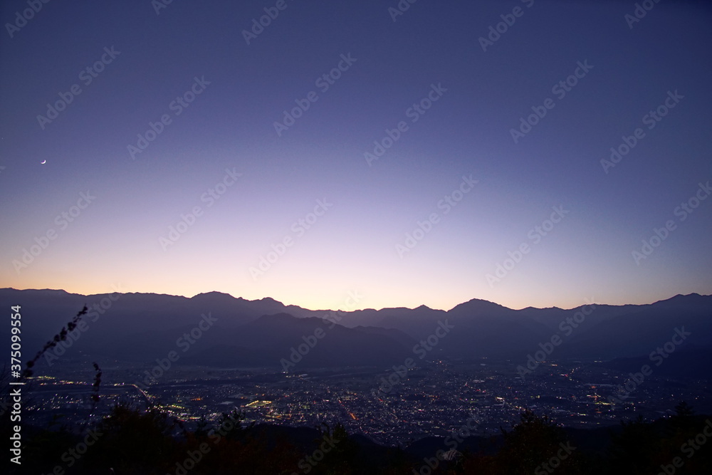 view of mountain silhouette on twilight sky after sunset, Japanese alps, Nagano, Japan view of mountain silhouette on twilight sky after sunset, Japanese alps, Nagano, Japan