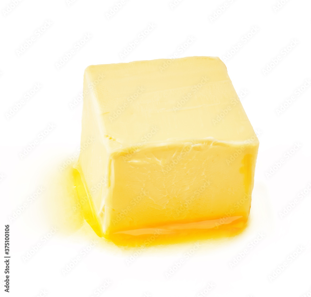 A piece of melting butter isolated on white background. Butter cube. A piece of melting butter isolated on white background. Butter cube.