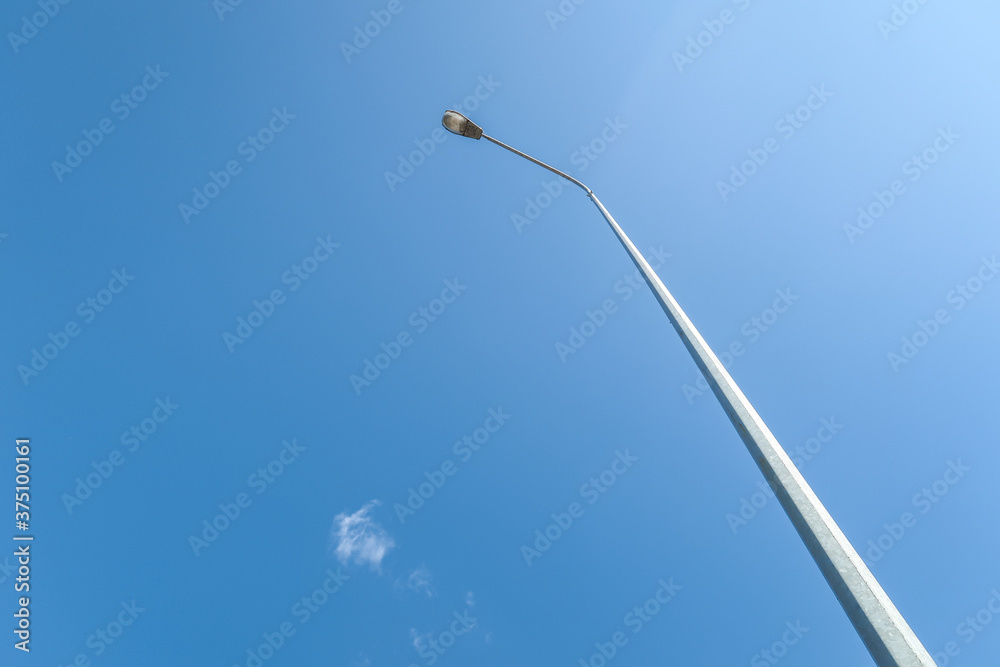 Street lamp against the blue sky during the day. Street lamp against the blue sky during the day.
