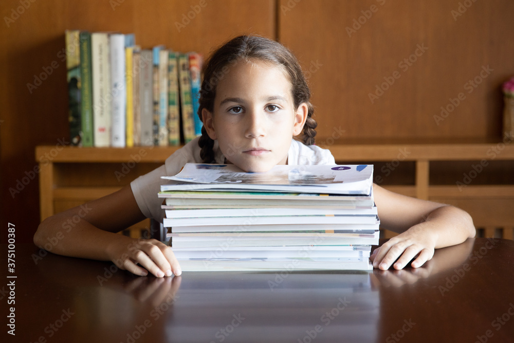 Young student tired of studying looking towards the camera Young student tired of studying looking towards the camera