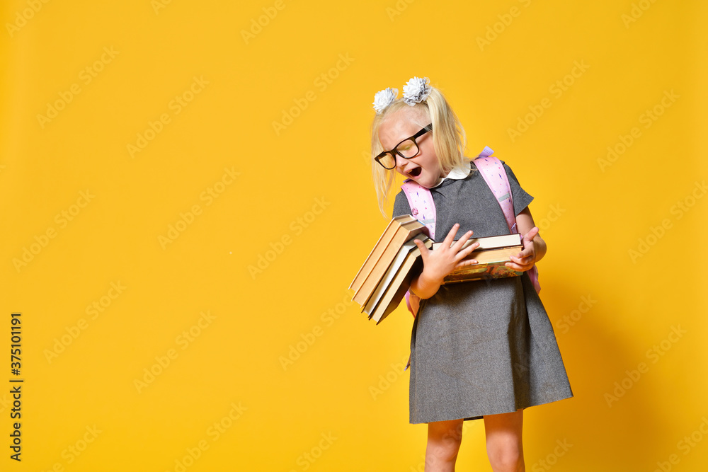 Fototapeta premium Young schoolgirl got tired of studying and dropped her books