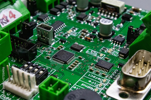 green circuitboard with microcontroller and lots of connectors