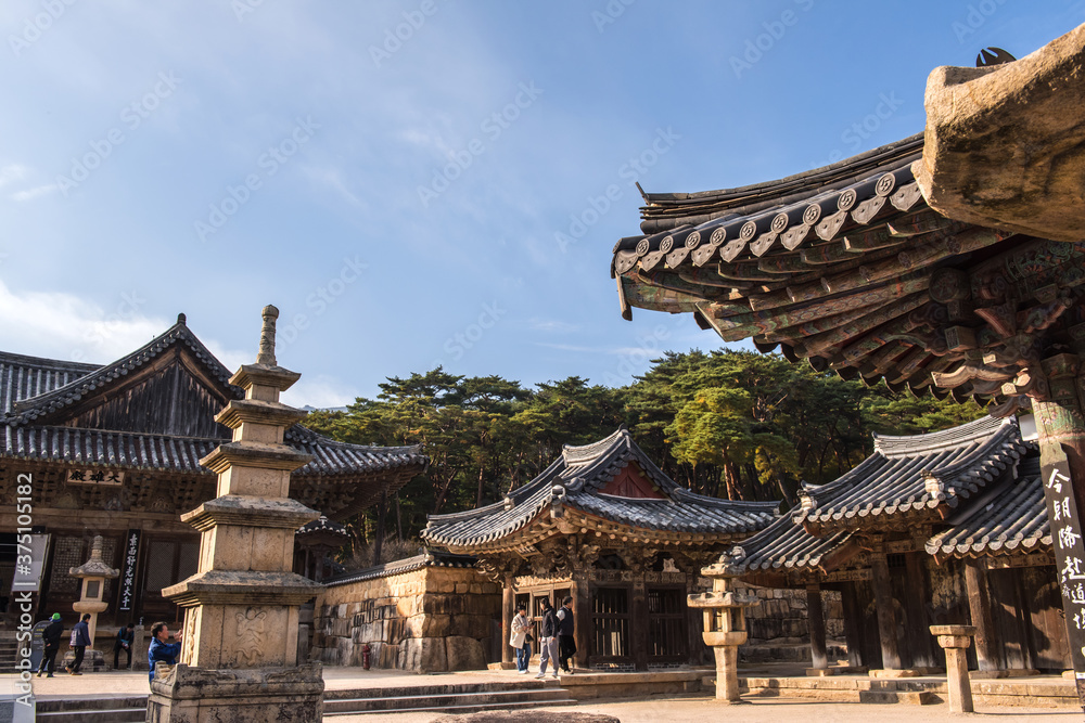 The beautiful and colorful autumn landscape of temple background autumn colored mountain and blue sky.