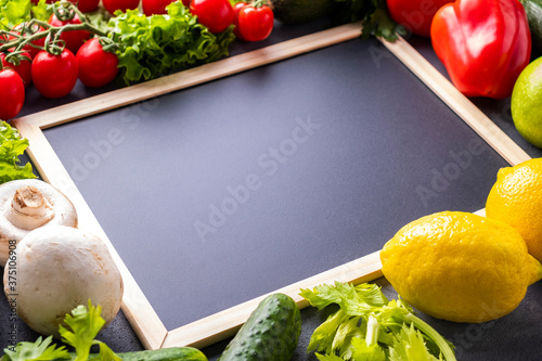 ?halk board with raw vegetables. Copy space photo