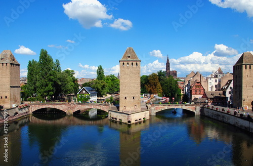 View on the towers and bridges of the Ponts Couverts (Covered Bridges) that cross the four river channels of the River Ill flowing through Strasbourg's historic Petite France quarter. 