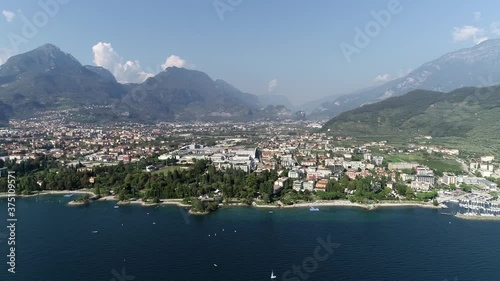 Aerial birds eye view footage of Riva del Garda cityscape is town and comune in the Italian province of Trento of the Trentino Alto Adige region at the northern tip of the lake 4k high resolution photo
