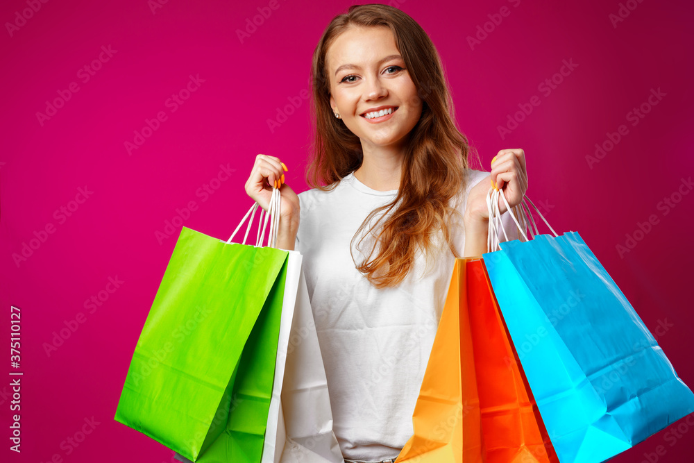 Portrait of happy young smiling woman with shopping bags