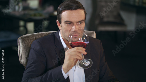 Business man eating food and drinking wine in restaurant. Businessman dining