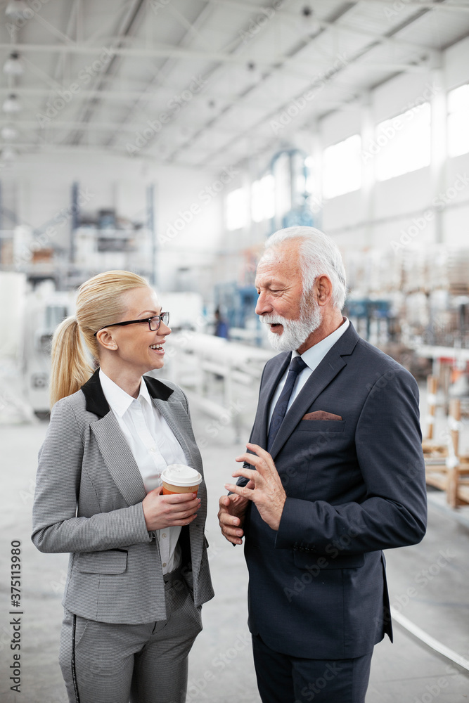 Man and woman discussing work. Colleagues working in factory. Man and woman discussing work. Colleagues working in factory.