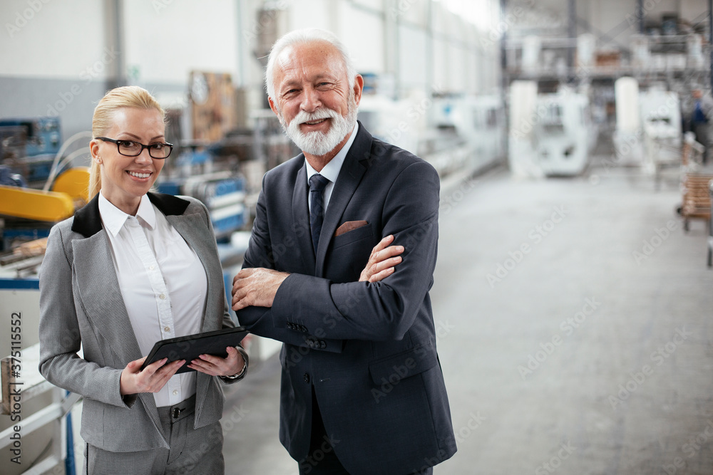Man and woman discussing work. Colleagues working in factory. Man and woman discussing work. Colleagues working in factory.