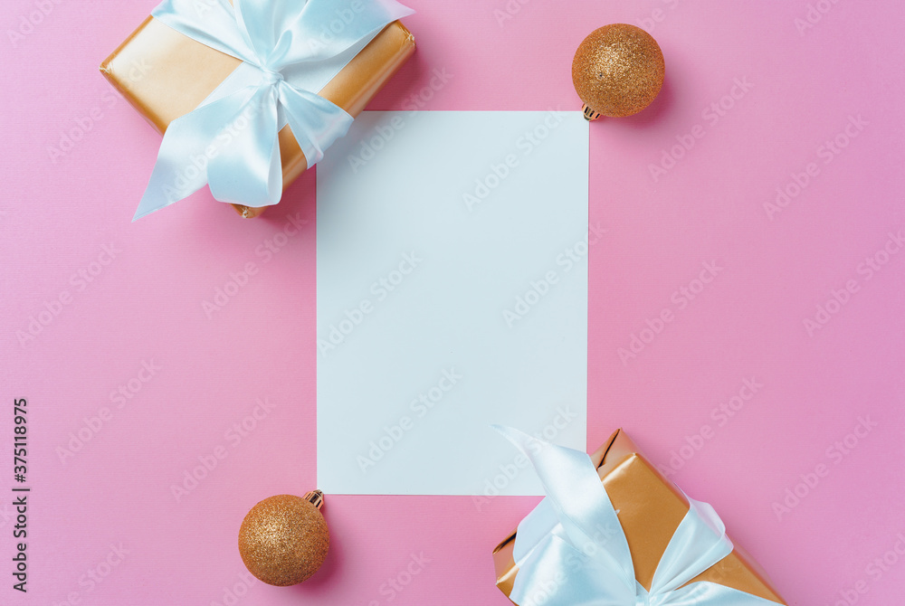Christmas festive mock up with blank page, wrapped gifts and baubles on pink Christmas festive mock up with blank page, wrapped gifts and baubles on pink