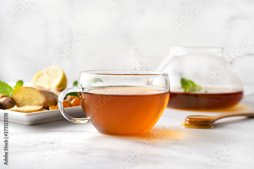 Lemon, honey, turmeric and ginger cup of tea on white background