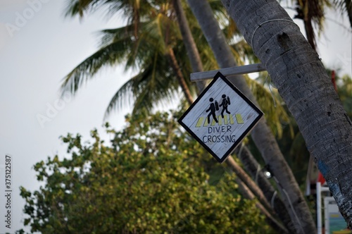 street sign on the beach, driver crossing sign board, watersport area