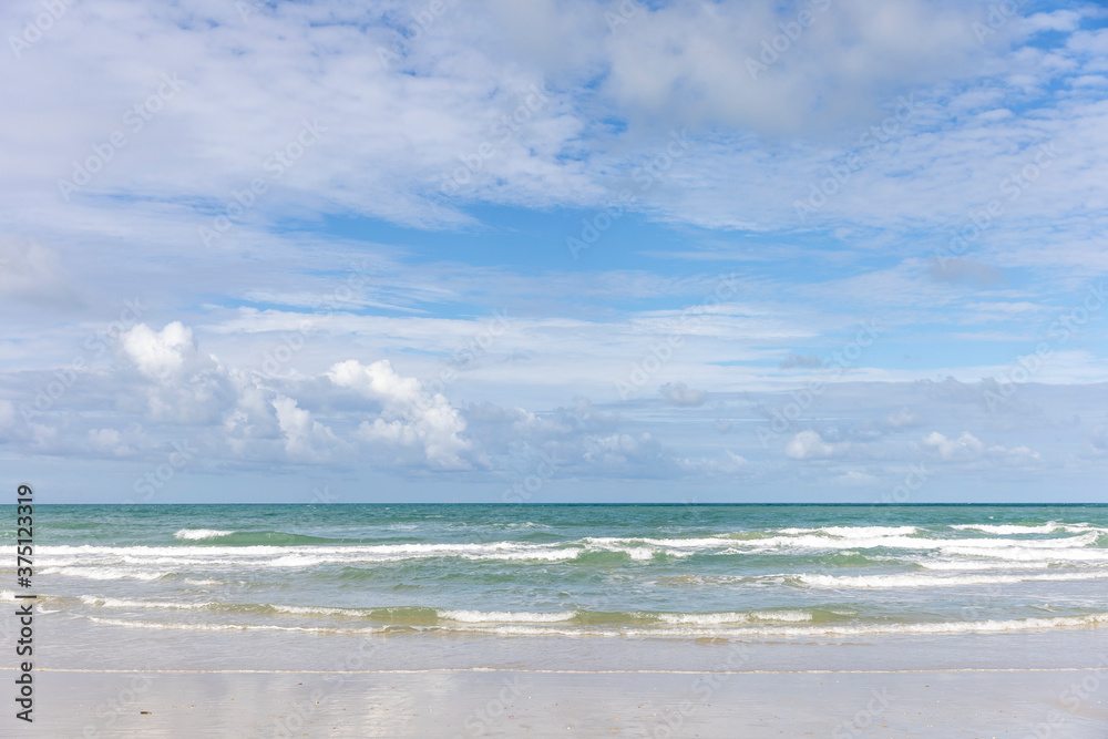 Seascape shot showing blue cloudy sky over a tropical sea on sunny day Seascape shot showing blue cloudy sky over a tropical sea on sunny day