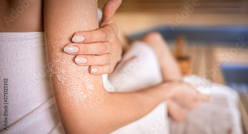 Принти на полотні Young woman applying natural scrub sitting in sauna