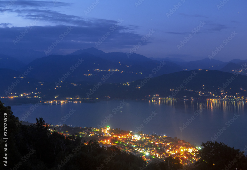 night view of Lake Maggiore from Mottarone, Baveno and other illuminated villages on the mountains, glow in the dark