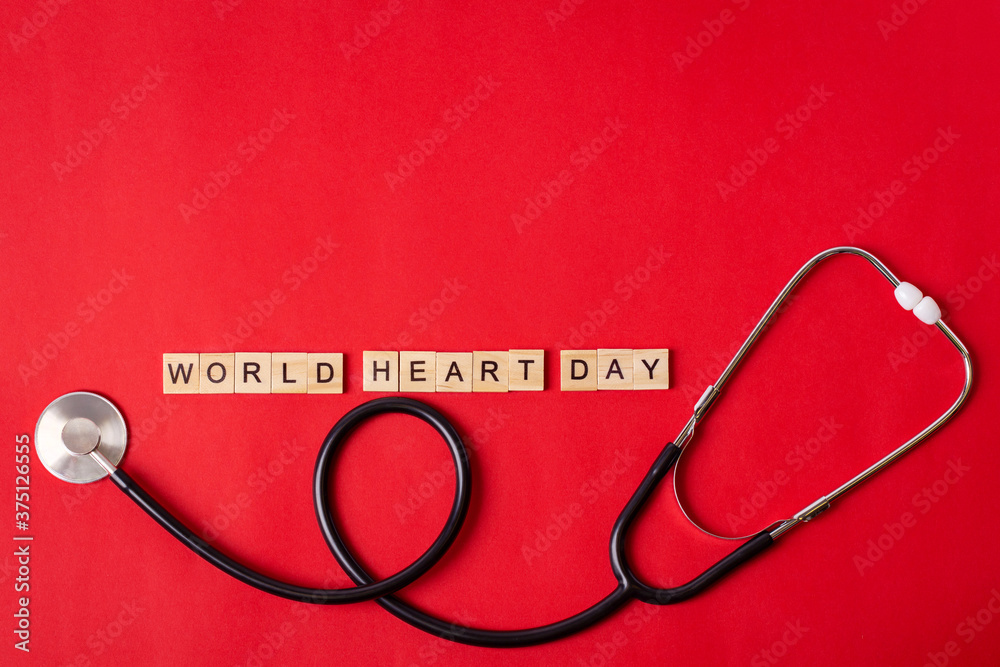 world heart day text with stethoscope on red background, health insurance concept, world health day, world heart day concept. world heart day text with stethoscope on red background, health insurance concept, world health day, world heart day concept.