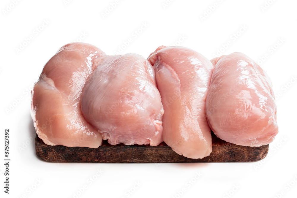 Fresh raw chicken breast on wooden board isolated on white