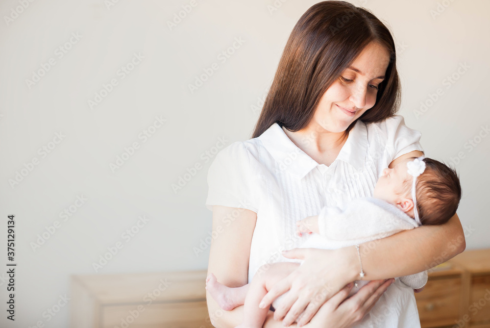 Family, happy childhood and maternity concept. Indoor shot of attractive young European mother Family, happy childhood and maternity concept. Indoor shot of attractive young European mother