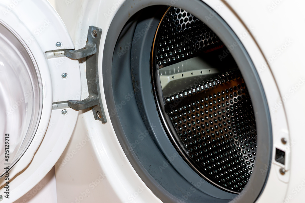 Old dirty washing machine close up, selective focus, door open Old dirty washing machine close up, selective focus, door open