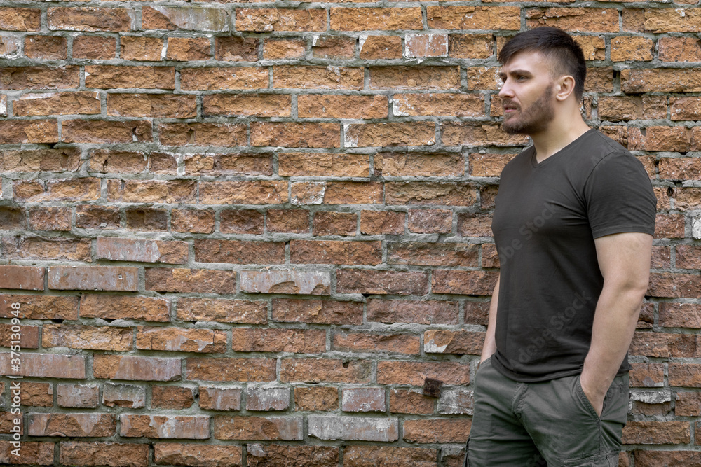Bearded man on a background of a brick wall. Bearded man on a background of a brick wall.