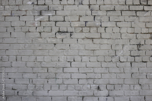 Grey brick wall. Weathered texture stained old paint grey brick wall. Colored brick wall background