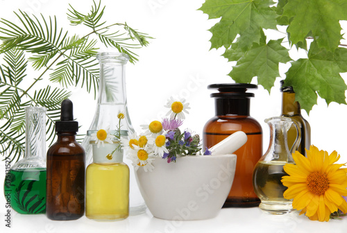 Bottles of tincture or concoction and fresh healthy herbs, herbal medicine.