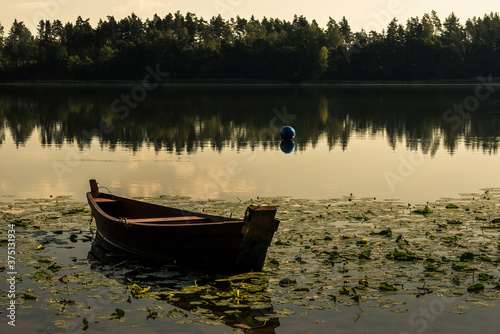 Fototapeta Naklejka Na Ścianę i Meble -  a boat on the lake in Masuria in Poland after sunset
