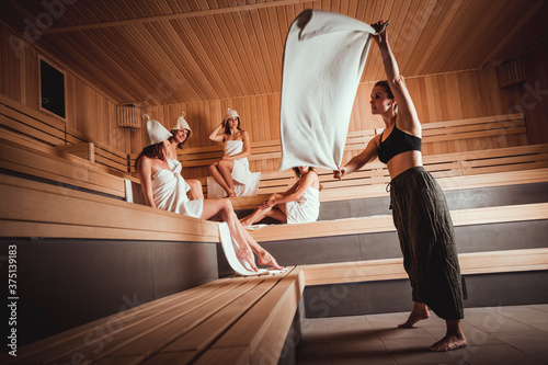 Sauna master making ritual in Finnish sauna photo