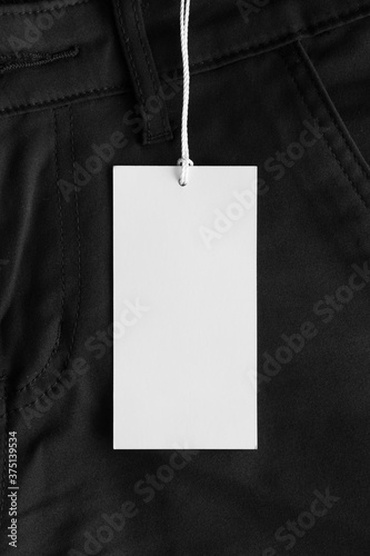 фотографія White tag mockup on a black pants.