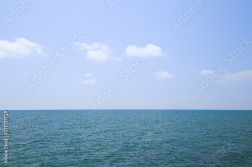 Beautiful calm sea and blue sky with white clouds.