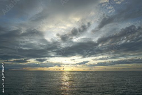 Sunset. Beautiful sunset at Japanese sea. Gold cloudy sky sunset. Picture Sea sunset.