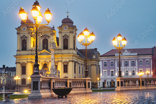 The rainy evening and night city lights on the Unirii Square of Timisoara, Romania photo