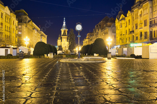 The rainy evening on the Victoriei Square of Timisoara, Romania photo