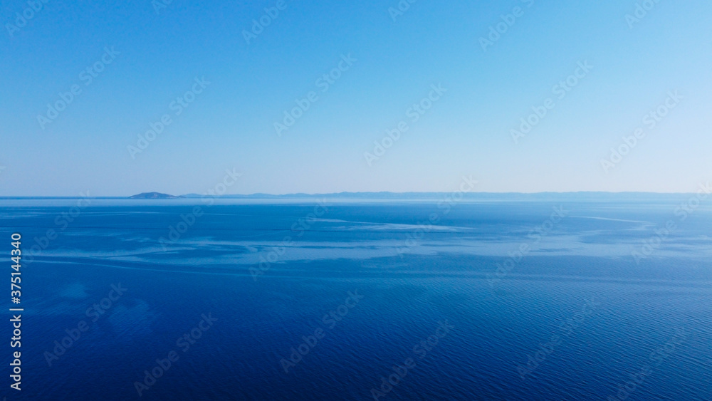 Obraz premium Open blue sea under blue sky.Aerial view 