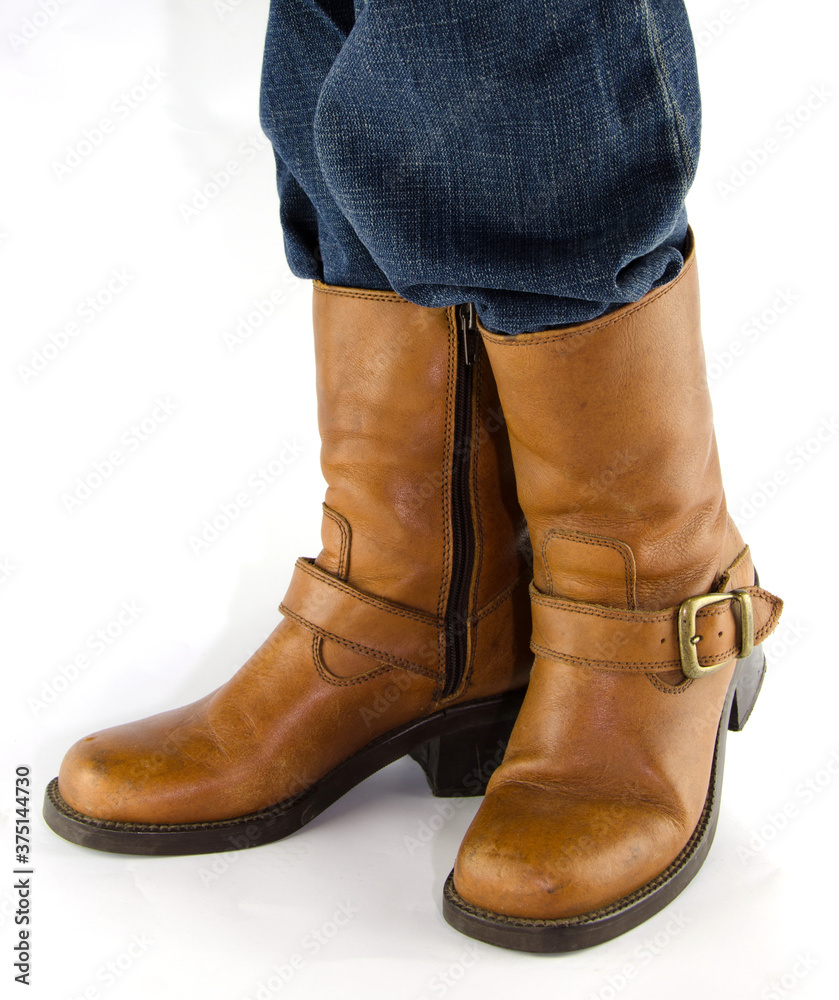 Legs in Jeans and Cowboys Boots with Text Space to the Left .