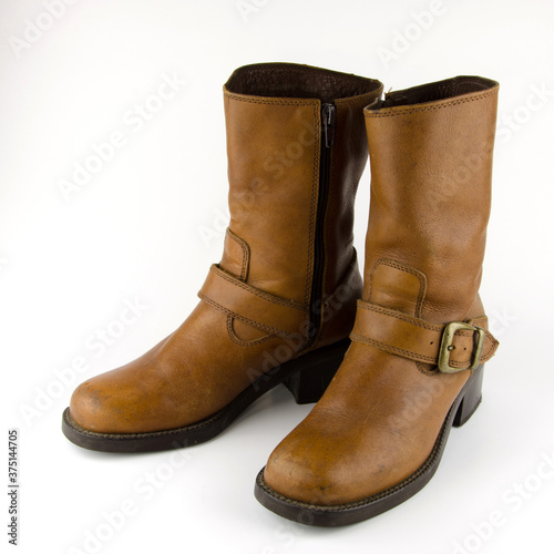 A pair of brown leather boots on a white background.