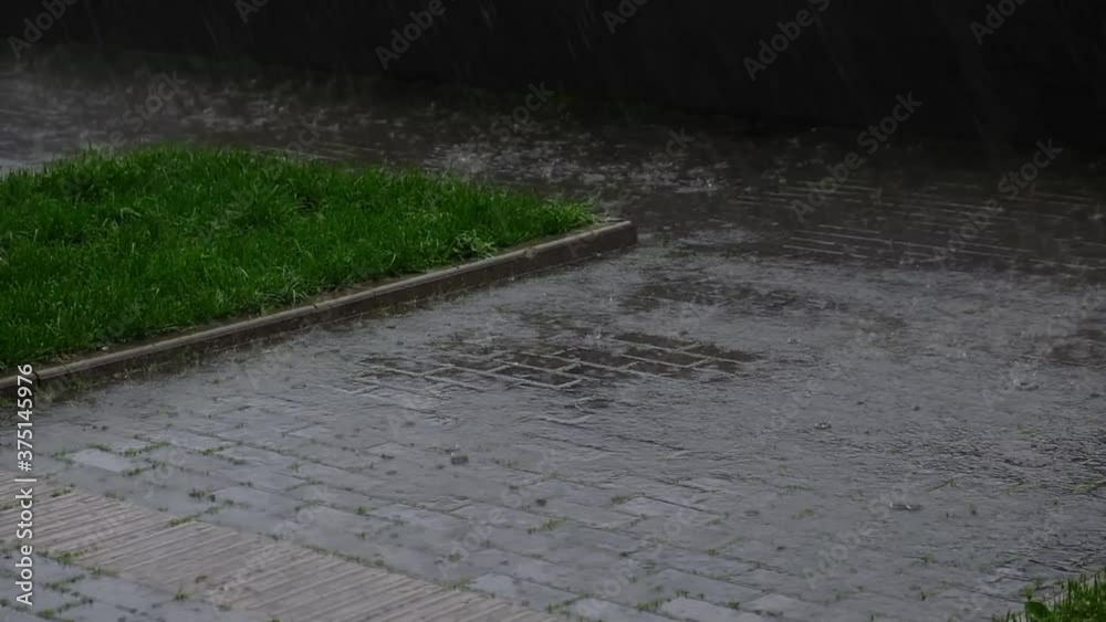 Rain in the city. heavy downpour, a puddle is gathering on the sidewalk. cloudy autumn, depressed mood. slow motion close up Shot video. Rain in the city. heavy downpour, a puddle is gathering on the sidewalk. cloudy autumn, depressed mood. slow motion close up Shot video.