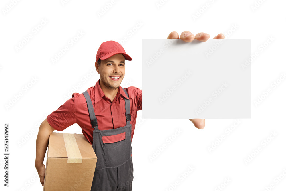 Smiling male courier holding a cardboard box and showing a blank card Smiling male courier holding a cardboard box and showing a blank card
