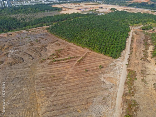 An aerial view of land clearing and deforestation at Iskandar Puteri of Nusajaya City in Johor Bahru city for new housing development projects, located in the Southern Corridor of Malaysia  photo