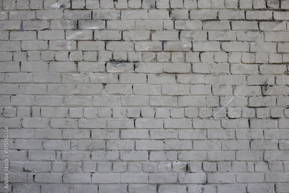 Grey brick wall. Weathered texture stained old paint grey brick wall. Colored brick wall background Grey brick wall. Weathered texture stained old paint grey brick wall. Colored brick wall background
