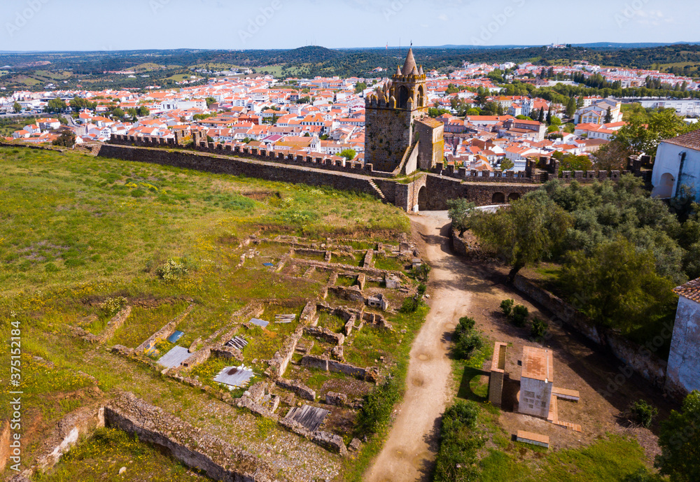 Aerial view of ruins of Montemor-o-Novo castle towering over settlement he once defended, Portugal