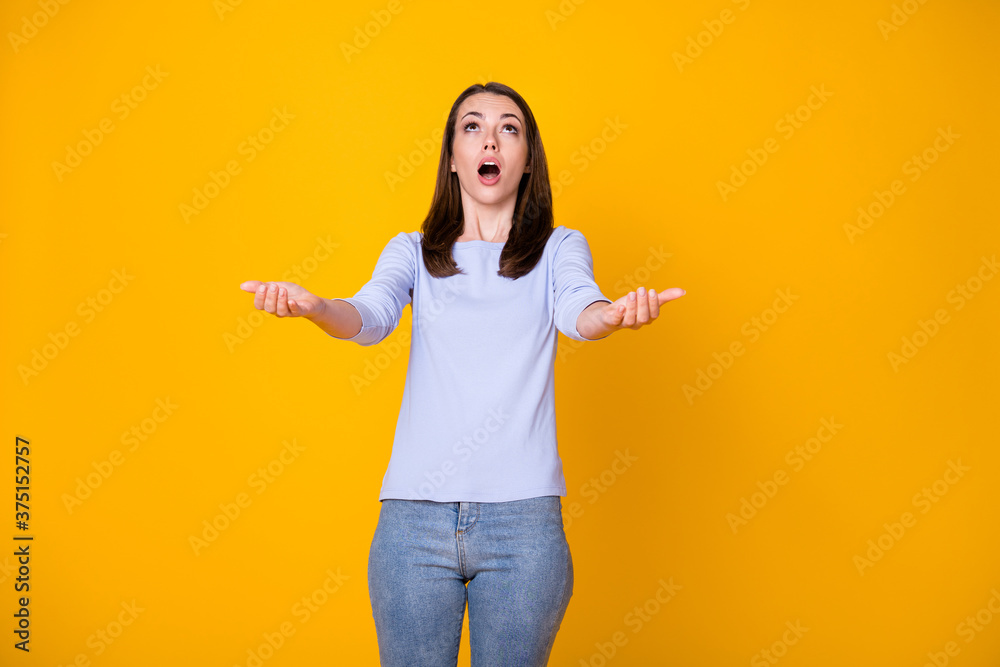 Photo of astonished girl look up copyspace hold hand try catch huge big discounts wear purple clothes isolated over bright color background Photo of astonished girl look up copyspace hold hand try catch huge big discounts wear purple clothes isolated over bright color background