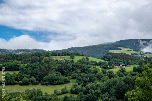 Green landscape  villages surrounded by fields and trees and mountains in south tyrol  south tyrol. Dolomites  Italy. Tourist accommodations and lodges.