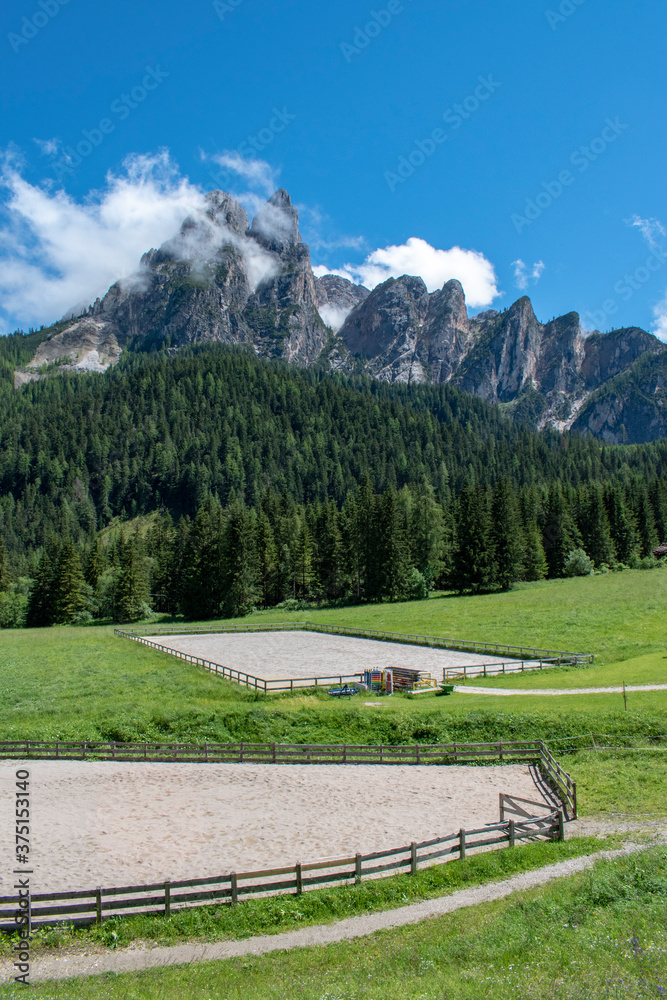 Panoramic view of a riding school in the Dolomites, mountain ranges. Oberhaus. Near the famous lake of Braies. South Tyrol. Bolzano. Italy 