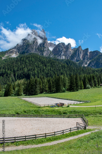 Panoramic view of a riding school in the Dolomites, mountain ranges. Oberhaus. Near the famous lake of Braies. South Tyrol. Bolzano. Italy 
