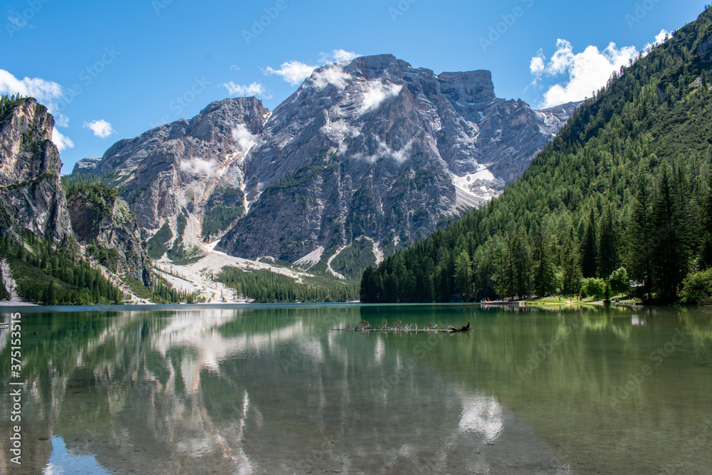 View of the Lake Braies, Pragser Wildsee is a lake in the Prags Dolomites, South Tyrol, Italy. Shadow of the trees, the mirror of pristine water, rocks, minerals and mountains. Covid free destinations